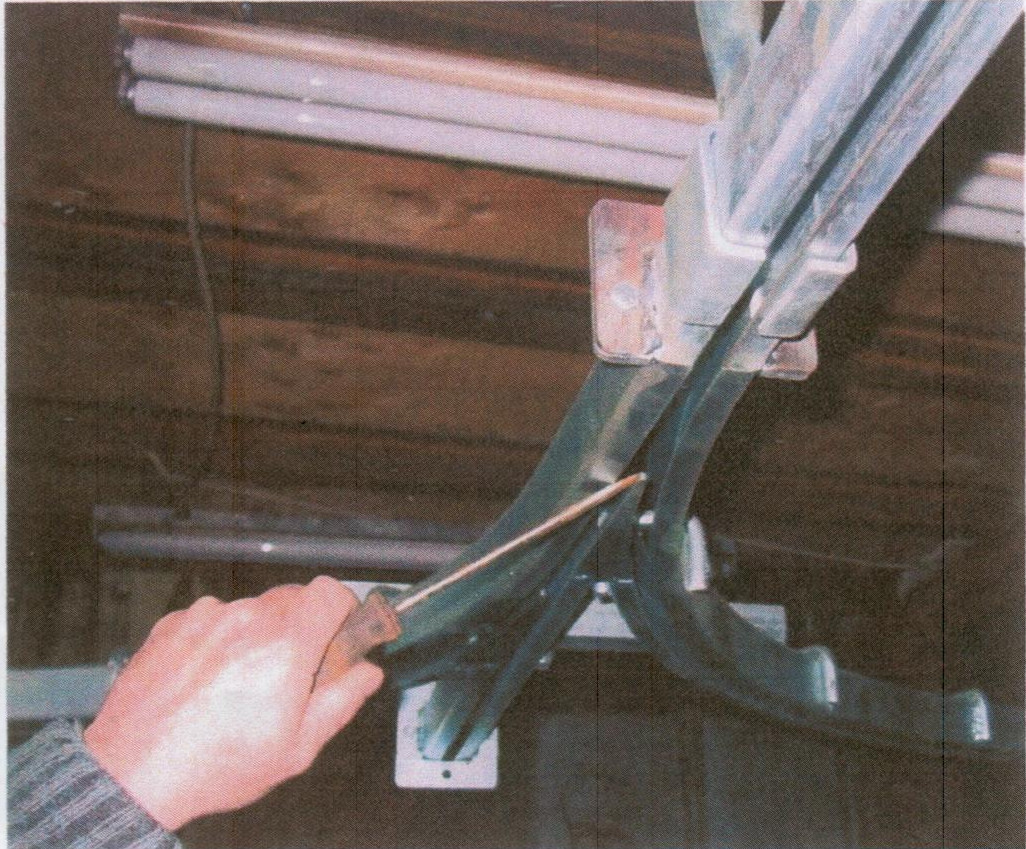 Using screwdriver to align switch of latrak conveyors